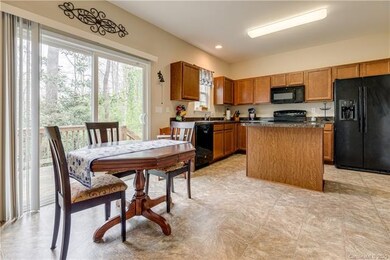 Open kitchen with island, refrigerator, washer/dry