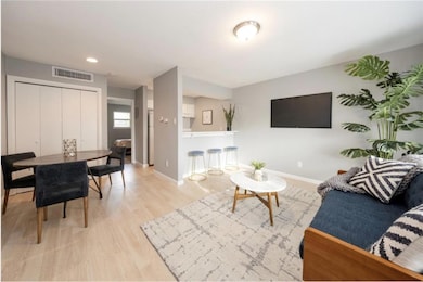 Living room with baseboards, wood finished floors