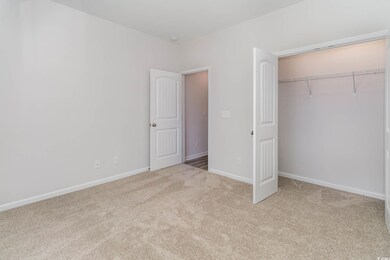 Unfurnished bedroom with light colored carpet and 