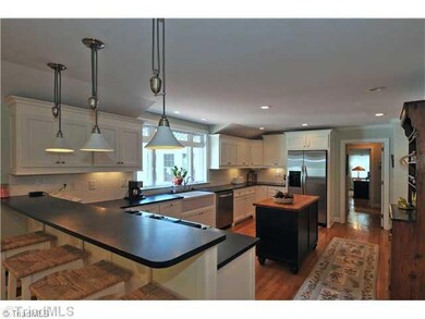 Kitchen. with honed granite counters, custom cabinets and farmhouse sink