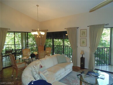Tiled living room with vaulted ceiling and a notab