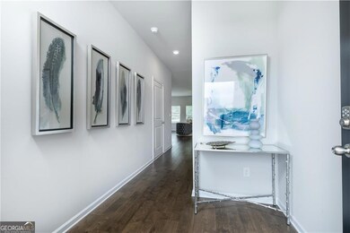 Corridor with dark wood-type flooring and recessed lighting