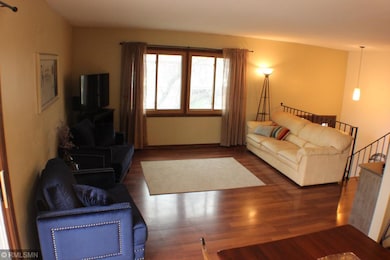 Living Room with beautiful flooring and large wind