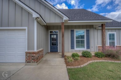 View of exterior entry with a garage