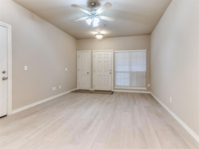 Unfurnished room featuring light wood-type flooring and ceiling fan