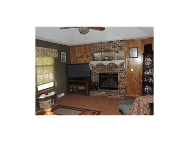 Living room with vaulted ceiling and a fireplace