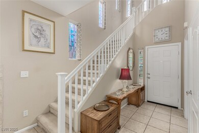 Entryway with stairs, high ceiling, and light tile
