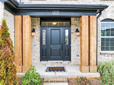 Entrance to property featuring brick siding