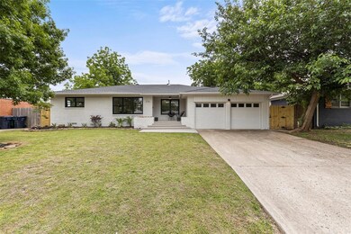 Ranch-style home featuring an attached garage, brick siding, and concrete driveway