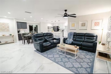 Living room featuring marble tiled floors, ceiling