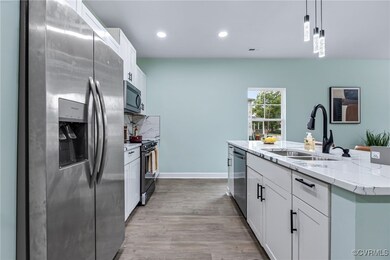 Kitchen featuring pendant lighting, white cabinets