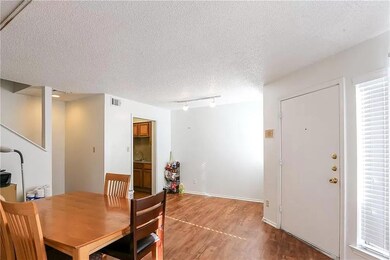 Dining space with wood finished floors, rail ligh