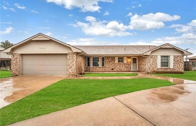 Single story home with a garage and a front lawn