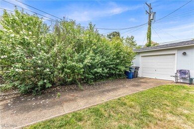 View of yard featuring an outbuilding and a garage