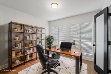 Home office with baseboards and wood finished flo