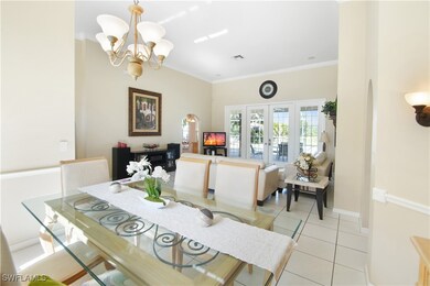 Tiled dining room with french doors, crown molding