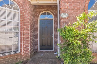 View of exterior entry with brick siding