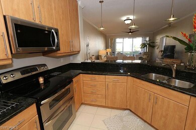 Kitchen with dark stone counters, sink, decorative