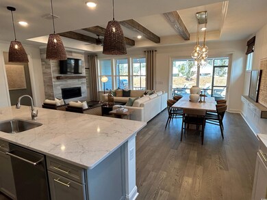 Kitchen featuring pendant lighting, a sink, open f