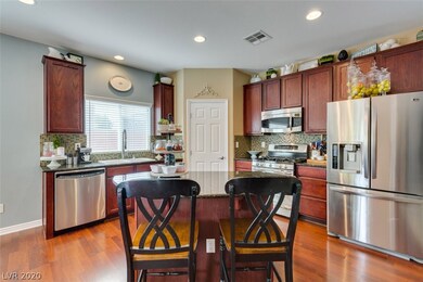 Upgraded kitchen with dark cherry cabinets, stainl