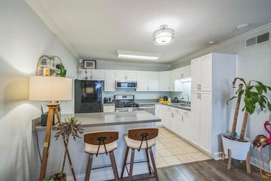 Kitchen with stainless steel appliances, a breakf