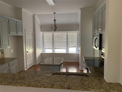 Kitchen with dark hardwood / wood-style flooring, 