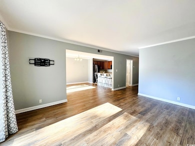 Unfurnished living room featuring hardwood / wood-