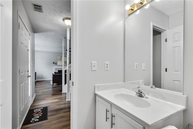 Half bathroom with toilet and vanity