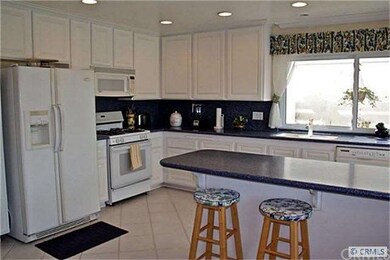 Inviting kitchen with wrap around windows and a br