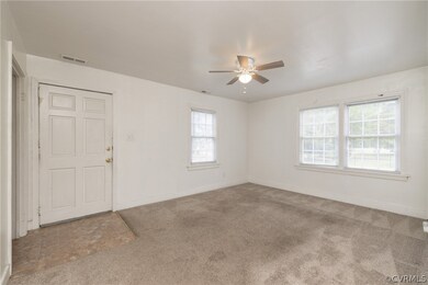 Spare room with carpet and ceiling fan