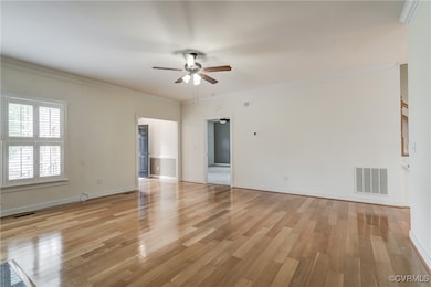 Family room featuring ceiling fan, light wood-type