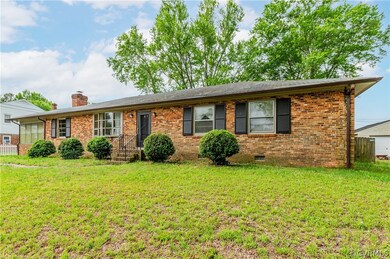 Ranch-style home featuring a front lawn