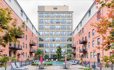 View of apartment building / complex featuring a community pool