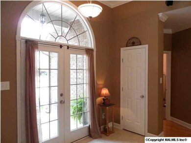 Double French Doors with arched windows greet your guests.