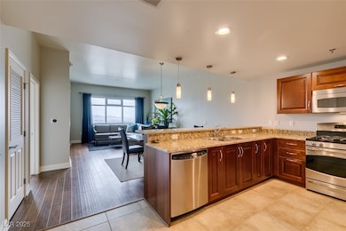 Kitchen featuring stainless steel appliances, a si