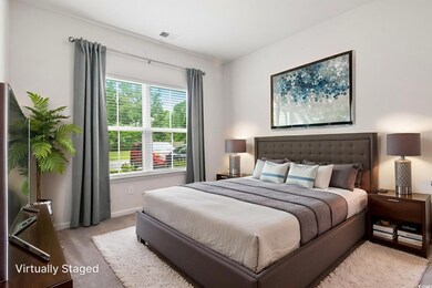 Bedroom with light carpet and baseboards