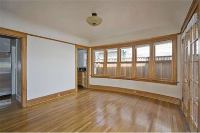 Unique curved wall of double hung windows in dining area. Flooded with natural light.