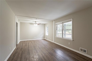 Unfurnished room featuring dark wood-type flooring