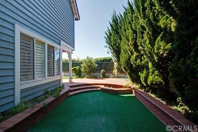 Sunken side yard with padded, artificial turf and 