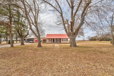 Ranch-style home featuring a porch and a front law