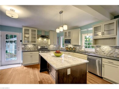 Renovated kitchen with granite counters, glass spl