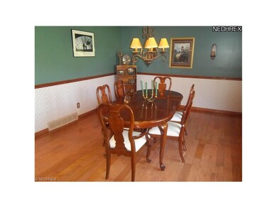 Formal Living Room presently used as Dining Room has hardwood floors and a bayed window.