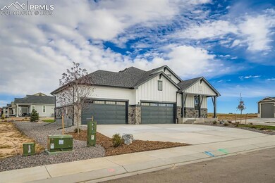 View of front of home with board and batten siding, roof with shingles, driveway, stone siding, and an attached garage