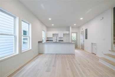 Kitchen featuring stone countertops, white cabinet