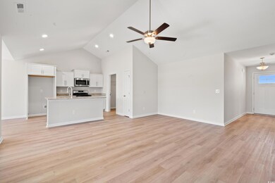 Unfurnished living room featuring light wood-type flooring, ceiling fan, high vaulted ceiling, and recessed lighting