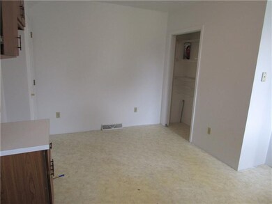 eat in kitchen with white walls and neutral floori