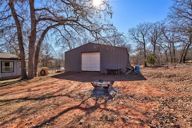 View of outbuilding featuring a garage and an outd