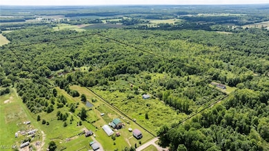 Aerial view of property and surrounding area featuring property boundaries highlighted