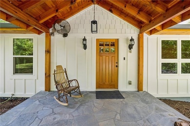 Entrance to property featuring board and batten siding