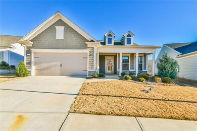 View of front of property with a garage and covere